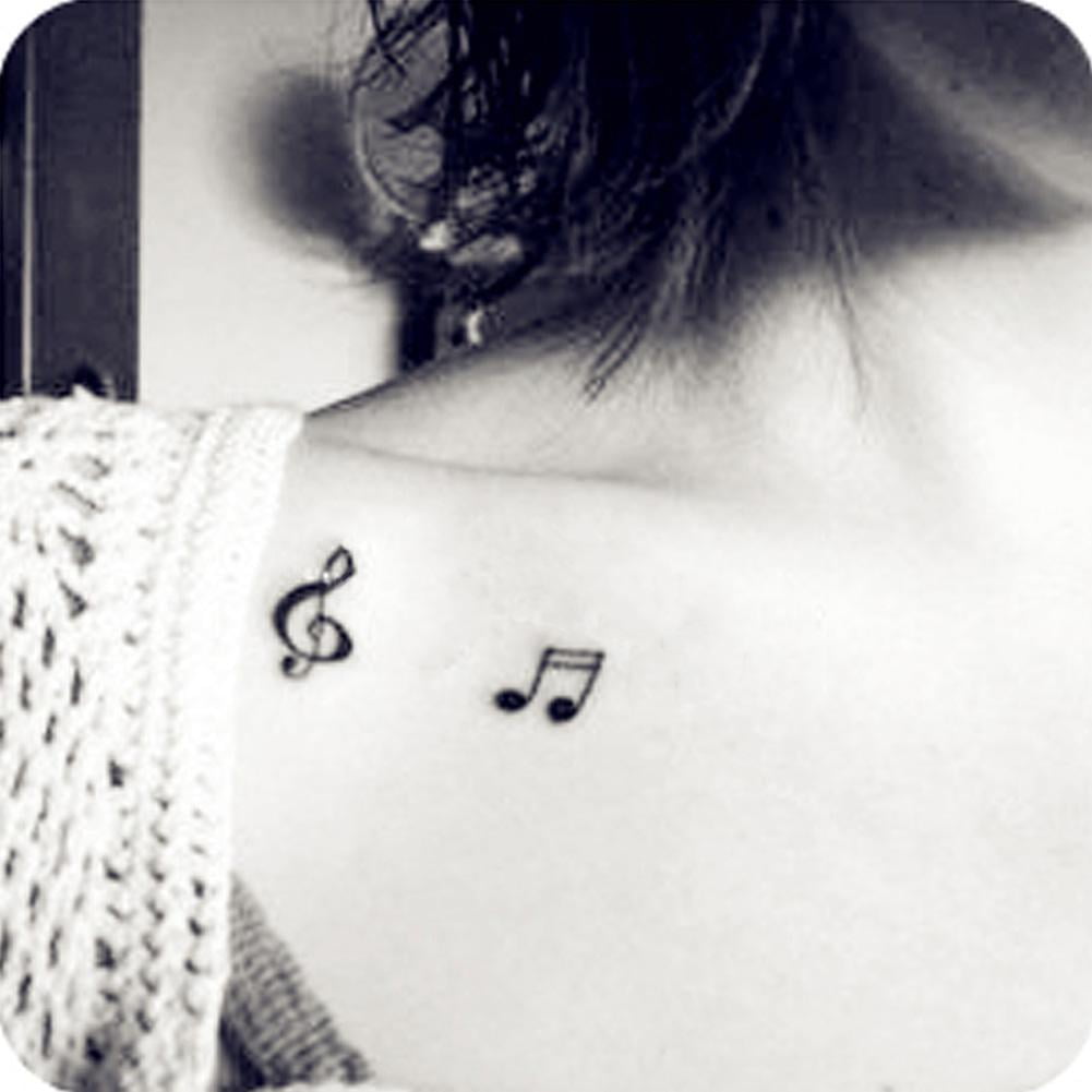 Minimalist waves and music notes tattoo on the inner